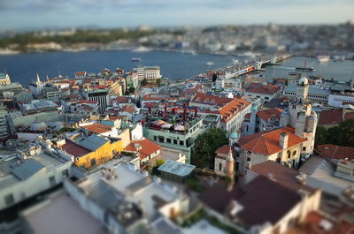 Aerial view of cityscape by sea against sky