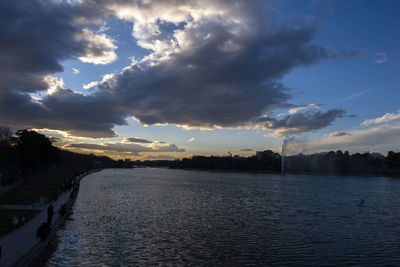 Scenic view of river against sky at sunset