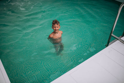 High angle view of boy in swimming pool