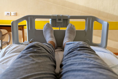 Concept health and medicine, selfie of feet with white socks of a patient sitting in a hospital bed