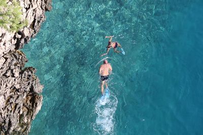 High angle view of people swimming in sea