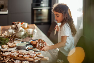 Side view of woman preparing food at home