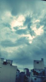 Low angle view of buildings against cloudy sky