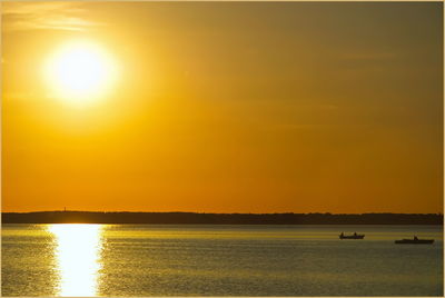 Scenic view of sea against orange sky