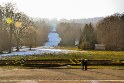 Scenic view of park by river against clear sky