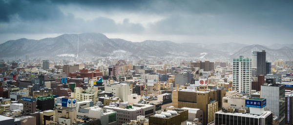 High angle view of buildings in city against sky