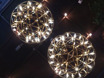 Low angle view of illuminated pendant lights hanging from ceiling