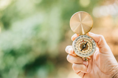 Cropped hand holding navigational compass