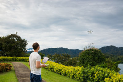 Full length of man standing on field against sky