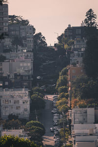 High angle view of buildings by river against sky