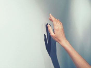 Hand sign shadow against white background