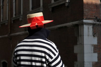 Midsection of man standing against building in city