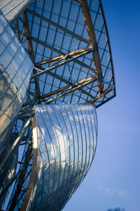 Low angle view of ferris wheel against blue sky