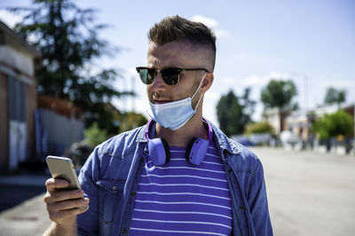 Portrait of young man using mobile phone