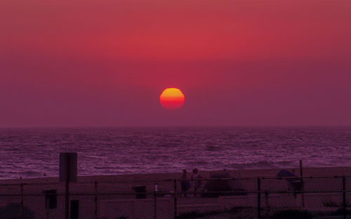 Scenic view of sea against orange sky