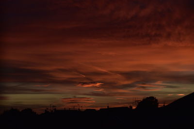 Scenic view of dramatic sky over silhouette landscape