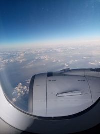 Aerial view of clouds seen through airplane window