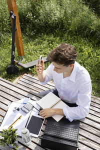 High angle view of young man working at table