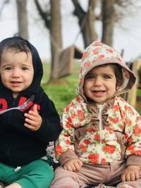 Portrait of a smiling girl sitting outdoors