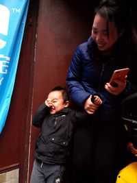 Smiling young woman using mobile phone