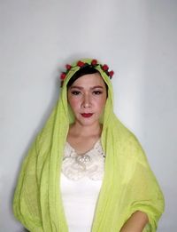 Portrait of a beautiful young woman against white background