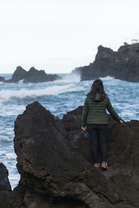 Woman walking against sea