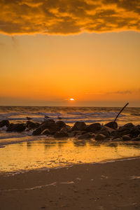 Scenic view of sea against orange sky