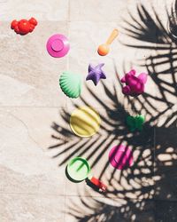 High angle view of plastic toys on floor during sunny day