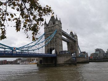 View of bridge over river against cloudy sky