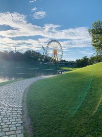 Ferris wheel in amusement park against sky