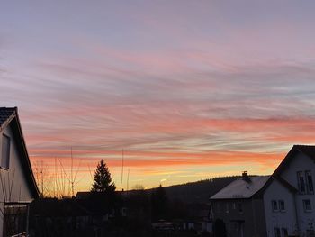 Silhouette buildings against sky during sunset