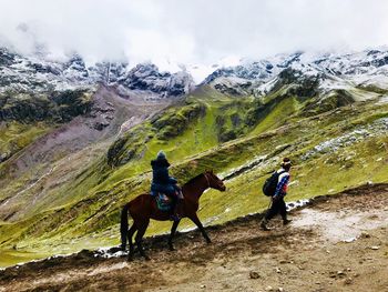 Men riding horses on mountain