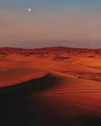 Scenic view of desert against sky during sunset