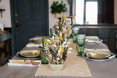 Rustic kitchen decor. dried flowers in a ceramic vase on the dining table