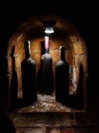 Close-up of old bottles against black background