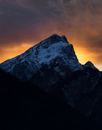 Scenic view of snowcapped mountains against sky during sunset