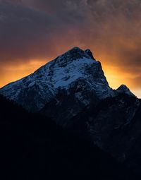 Scenic view of snowcapped mountains against sky during sunset