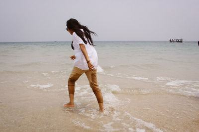 Full length of man standing on beach