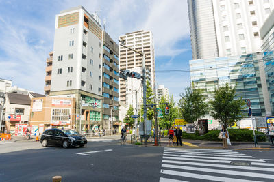 City street and buildings against sky