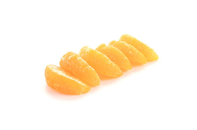 Close-up of orange fruit against white background