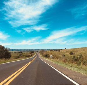 Empty road along countryside landscape