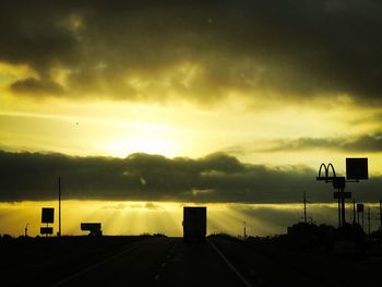 View of road against cloudy sky during sunset