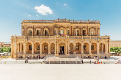 Group of people in front of historical building