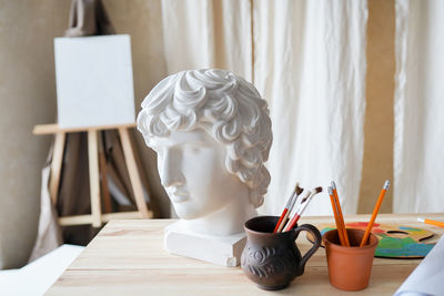 Close-up of mannequin on table at home