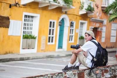 Male tourist taking pictures of the beautiful at cartagena de indias walled city