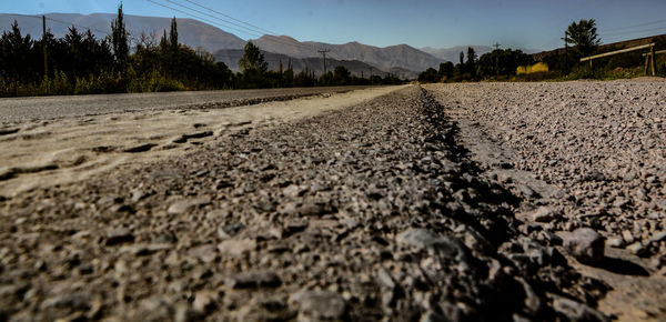 Surface level of road on field against sky