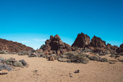 Rock formations in desert against blue sky