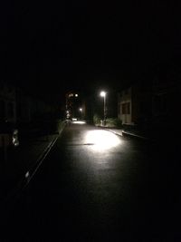 Illuminated street light against clear sky at night