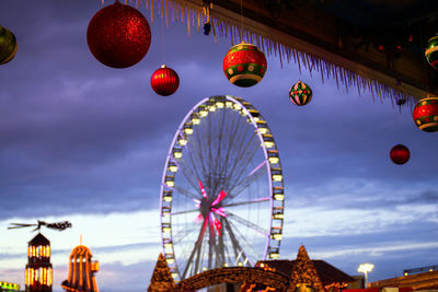 Low angle view of ferris wheel against sky