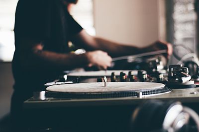 Close-up of turntable and man